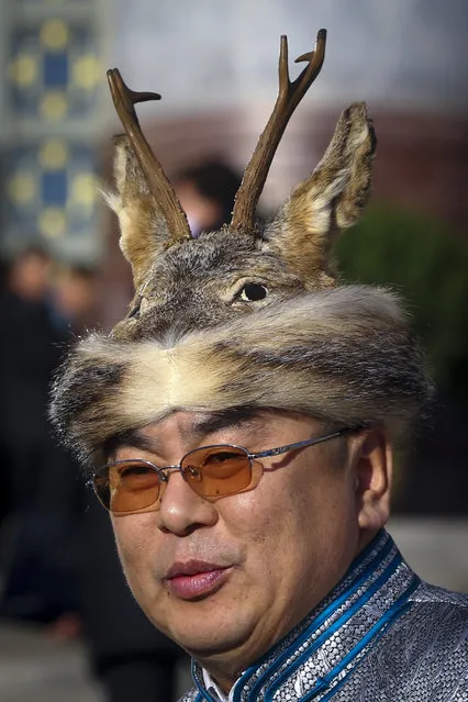 A delegate from the Oroqen ethnic minority wearing a deer arrives at the Great Hall of the People for the opening session of the National Peoples Congress (NPC) in Beijing, China, March 5, 2014. (Photo by Diego Azubel/EPA)
