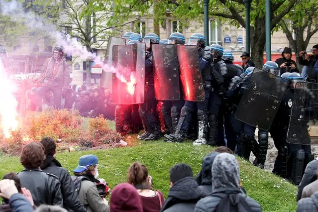 French police clash with protesters as French labour union workers and students attend a demonstration against the labour law proposal in Paris, France, April 9, 2016. (Photo by Charles Platiau/Reuters)