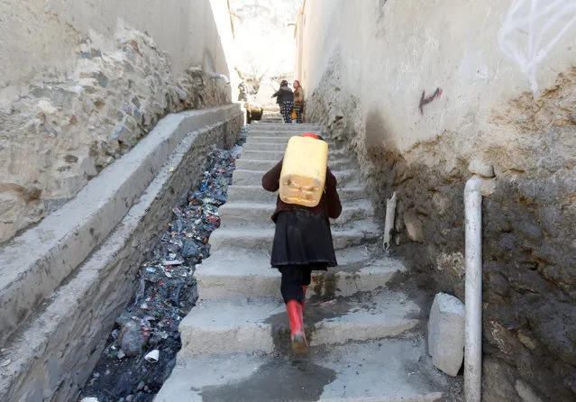 An Afghan girl carries water on her back as she climbs a hill in Kabul, Afghanistan February 20, 2017. (Photo by Omar Sobhani/Reuters)