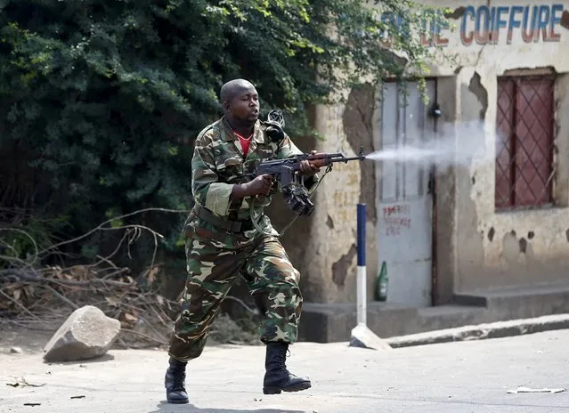 A soldier fires an AK-47 rifle during a protest against President Pierre Nkurunziza and his bid for a third term, in Bujumbura, Burundi, May 25, 2015. (Photo by Goran Tomasevic/Reuters)