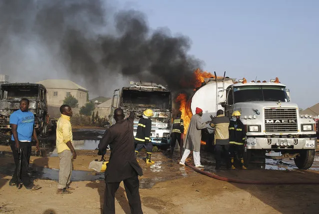 Firefighters try to contain a fire following a suicide attack at petrol tankers in Maiduguri, Nigeria, Friday, March. 3, 2017. Three suicide bombers set ablaze three fuel tankers in the center of Nigeria's northeastern city of Maiduguri before dawn Friday, officials said, just days before a planned visit by the U.N. Security Council. (Photo by Jossy Ola/AP Photo)