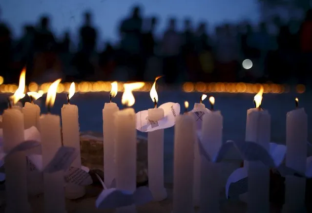 Lit candles are lined up during a candlelight vigil, a month after the April 25 earthquake, in Kathmandu, Nepal May 25, 2015. (Photo by Navesh Chitrakar/Reuters)