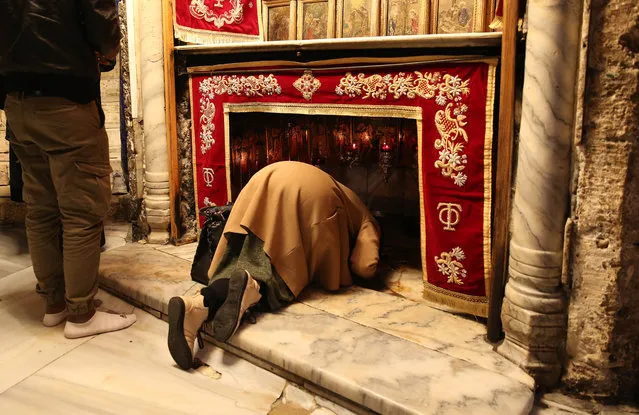 A faithful prays in the Church of the Nativity to attend Eastern Christmas celebrations in the West Bank city of Bethlehem, 06 January 2021. (Photo by Abed Al Hashlamoun/EPA/EFE)