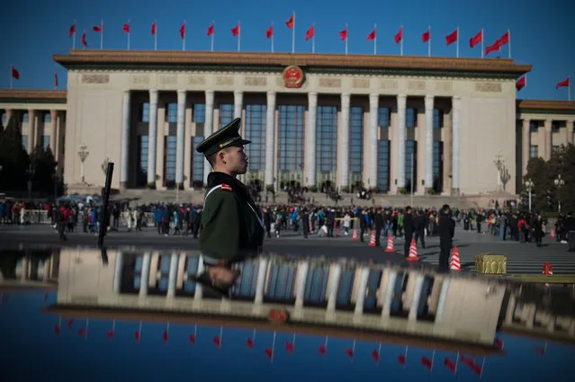 A paramilitary police officer stand guard during the opening of the National People' s Congress in Beijing on March 5, 2017. China' s rubber- stamp congress opened on March 5, 2017 in an annual pageant of Communist- controlled democracy. (Photo by Nicolas Asfouri/AFP Photo)