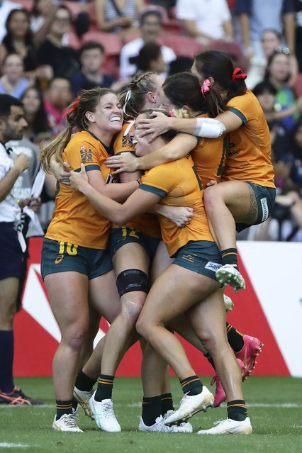 Australian players celebrate after defeating France during the women's HSBC World Rugby Sevens Series 2024 cup semifinals between Australia and France in Singapore, on Sunday, May 5, 2024. (Photo by Suhaimi Abdullah/AP Photo)