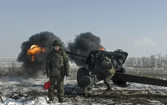 In this photo taken from video provided by the Russian Defense Ministry Press Service on Friday, January 28, 2022, Russian troops fire howitzers during drills in the Rostov region during a military exercising at a training ground in Rostov region, Russia. (Photo by Russian Defense Ministry Press Service via AP Photo)