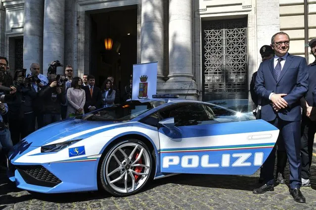 Stefano Domenicali (R), Chief Executive Officer of Automobil Lamborghini, stands next to the new police's car Lamborghini “Huracan” during a press conference at the Interior Ministry “Viminale” in Rome, on March 30, 2017. (Photo by Andreas Solaro/AFP Photo)