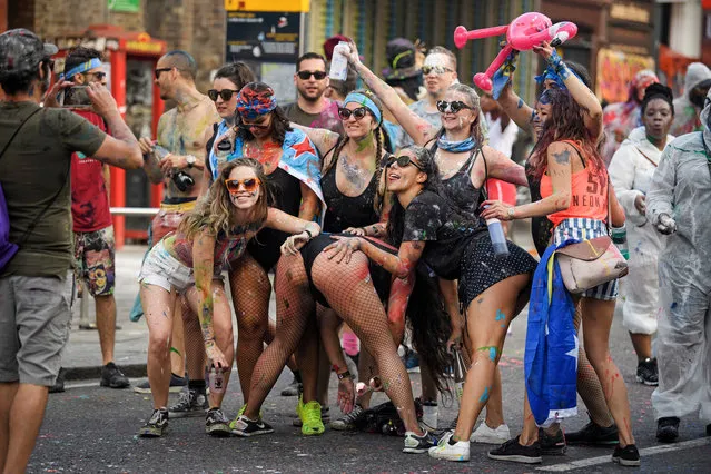 Boozed up revellers dressed up in fluorescent colours during the opening day of the 2019 Notting Hill Carnival on August 25, 2019 in London, England. Up to a million people are expected to pack the streets of Notting Hill and surrounding areas over the course of the two day event. The annual celebration of Afro-Caribbean culture takes place each August bank holiday weekend. (Photo by London News Pictures)