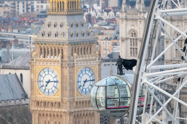 A man dressed as superhero Batman stands on top of a pod on the lastminute.com London Eye, the landmark tourist attraction in central London on Monday, February 28, 2022, ahead of the release of The Batman in UK cinemas on March 4. (Photo by Dominic Lipinski/PA Images via Getty Images)