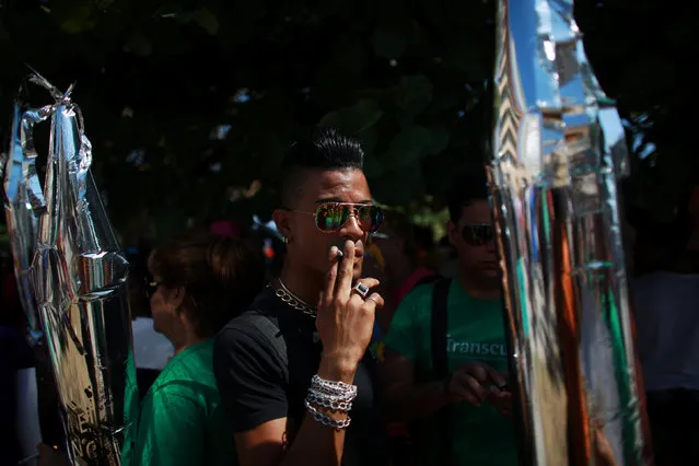 A participant smokes a cigarette before the Annual March against Homophobia and Transphobia in Havana, May 14, 2016. (Photo by Alexandre Meneghini/Reuters)