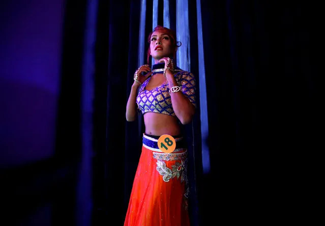 A contestant gets ready to enter the podium of Miss Pink Beauty Pageant in Kathmandu, Nepal, May 17, 2016. (Photo by Navesh Chitrakar/Reuters)