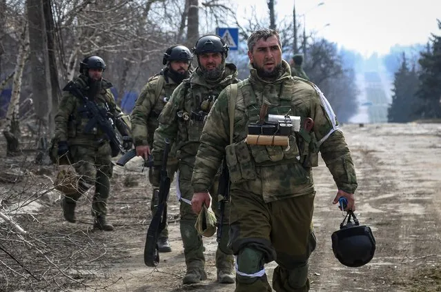 Service members from Chechen Republic walk during fighting in the Ukraine-Russia conflict in the city of Mariupol, Ukraine on March 31, 2022. (Photo by Chingis Kondarov/Reuters)