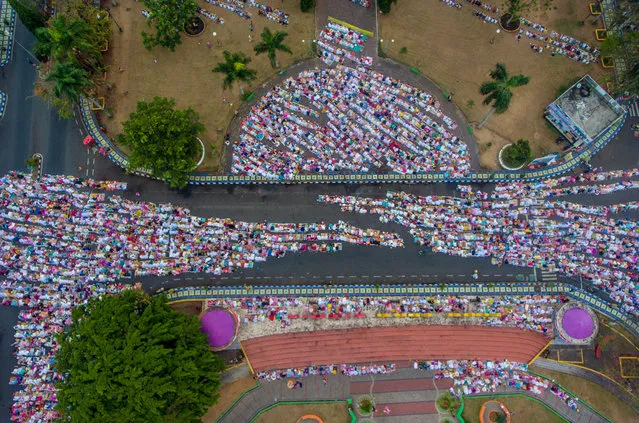 An aerial picture of Indonesian Muslims offering Eid al-Adha prayers in Ciamis, West Java province, Indonesia, August 11, 2019. (Photo by Adeng Bustomi/Antara Foto via Reuters)