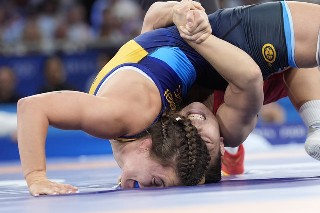 China's Qianyu Pang and Sweden's Emma Jonna Malmgren compete in their women's freestyle 53kg quarterfinal wrestling match, at Champ-de-Mars Arena, during the 2024 Summer Olympics, Wednesday, August 7, 2024, in Paris, France. (Photo by ugene Hoshiko/AP Photo/)