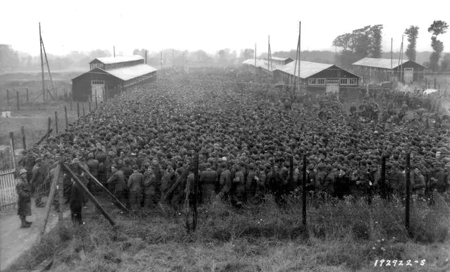 German prisoners of war captured after the D-Day landings in Normandy are guarded by U.S. troops at a camp in Nonant-le-Pin, France, August 21, 1944. REUTERS/US National Archives