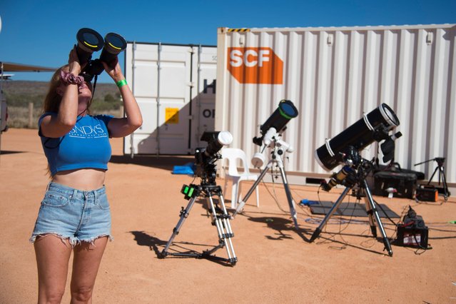 People gather ahead of a total solar eclipse in Exmouth, Western Australia on April 20, 2023. This partial solar eclipse is part of a hybrid solar eclipse that crosses the Pacific region. A hybrid solar eclipse is an infrequent kind of solar eclipse that alters its manifestation as the Moon's shadow travels across the Earth's terrain. (Photo by Aaron Bunch/dpa)