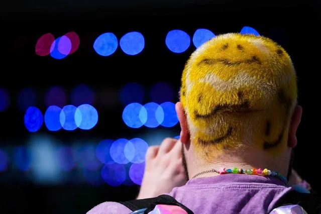 A man accessorized his hair by painting it in smiley faces attends the Coachella Valley Music Festival held at the Empire Polo Club in Indio, California, U.S., April 22, 2022. (Photo by Maria Alejandra Cardona/Reuters)