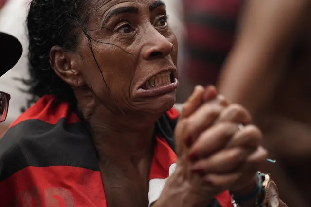 A fan of Brazil's Flamengo soccer team reacts after England's Liverpool scored a goal against her team as she watches a live broadcast of the FIFA Club World Cup final soccer match, at the Rocinha slum in Rio de Janeiro, Brazil, Saturday, December 21, 2019. (Photo by Leo Correa/AP Photo)