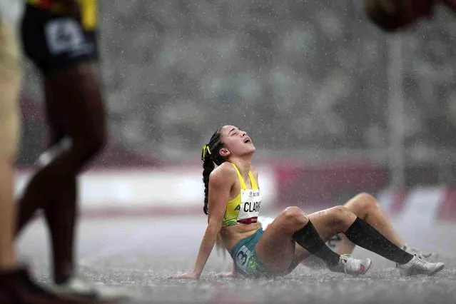 Australia's Rhiannon Clarke reacts in the rain after the women's T38 400-meters final at Tokyo 2020 Paralympic Games, Saturday, September 4, 2021, in Tokyo, Japan. (Photo by Emilio Morenatti/AP Photo)