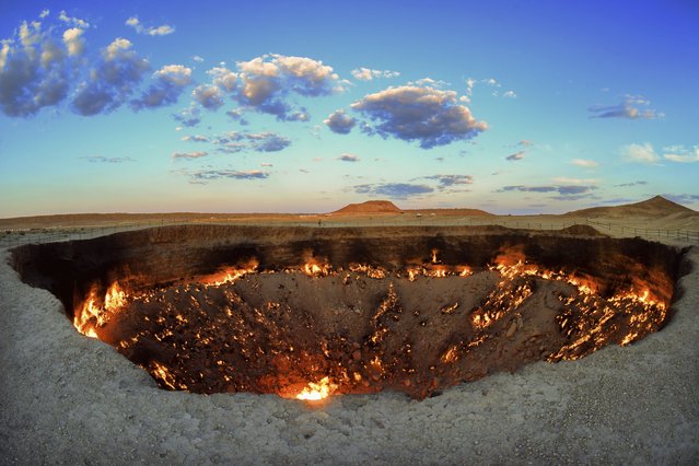 The crater fire named “Gates of Hell” is seen near Darvaza, Turkmenistan, Saturday, July 11, 2020. The president of Turkmenistan is calling for an end to one of the country's most notable but infernal sights – the blazing desert natural gas crater widely referred to as the “Gates of Hell”. The crater, about 260 kilometers (160 miles) north of the capital Ashgabat, has been on fire for decades and is a popular sight for the small number of tourists who come to Turkmenistan, which is difficult to enter. (Photo by Alexander Vershinin/AP Photo)