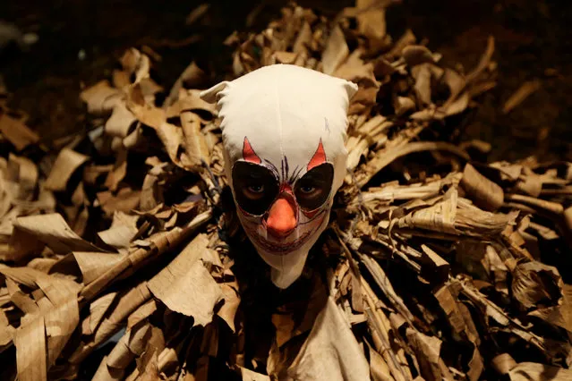 A youth disguised as a Guaikuru takes part in the Kamba Ra'Anga celebration, which originated during colonial times and is based on Spanish, Indigenous and African customs, in Altos, Paraguay June 29, 2017. (Photo by Jorge Adorno/Reuters)