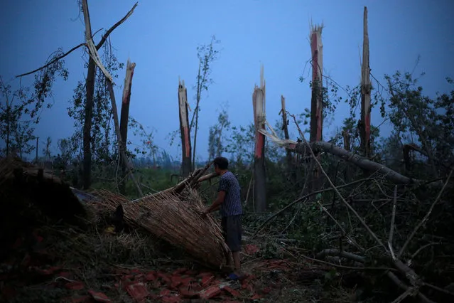 A villager takes out his belongings from his damaged house after a tornado hit Funing on Thursday, in Yancheng, Jiangsu province, June 24, 2016. (Photo by Aly Song/Reuters)
