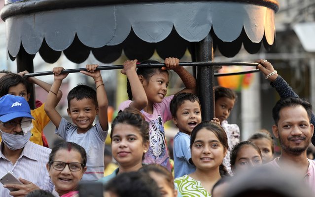 People watch a Dussehra festival procession early morning in Prayagraj, Uttar Pradesh, India, Tuesday, October 8, 2024. (Photo by Rajesh Kumar Singh/AP Photo)