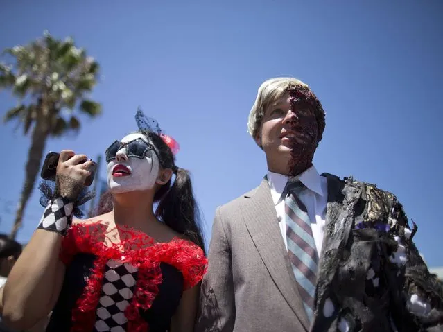 Christine and Justin Skolek walk outside during Comic-Con Thursday, July 24, 2014, in San Diego. Thousands of fans with four-day passes to the sold-out pop-culture spectacular flocked to the event Thursday, many clad in costumes. (Photo by AP Photo)