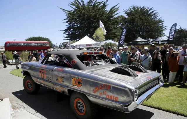 A 1964 Ford Fairline drives off after winning the “Worst of Show” award at the Concours d'Lemon, a part of the Pebble Beach Concours d'Elegance in Seaside, California, August 15, 2015. When it began 65 years ago, the Pebble Beach Concours d'Elegance was just a one-day affair. Car enthusiasts raced around Pebble Beach's famed 17-Mile Drive and hung around afterwards to admire each other's hardware. (Photo by Robert Galbraith/Reuters)