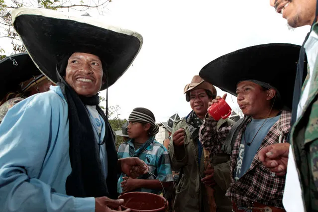 Ecuadorian indians take a drink as they commemorate San Juan festival, also known as Inti Raymi, around the community of Cotacachi June 29, 2016. (Photo by Guillermo Granja/Reuters)