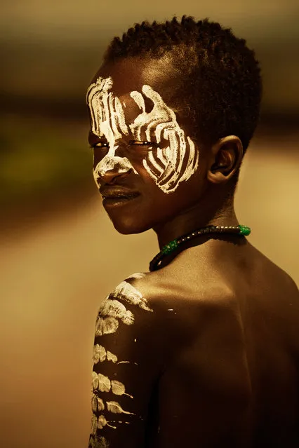 Mursi people, like many in the Omo Valley, paint their bodies using clay. The paint protects against sunburns, indicates how virile they are to women, how intimidating they are to other men, and supposedly wards off evil and disease. (Photo by Diego Arroyo)