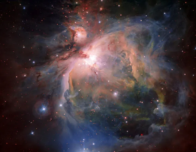 A handout photo made available by the European Southern Observatory (ESO) on 27 July 2017 shows the Orion Nebula and its associated cluster of young stars in great detail, captured by the OmegaCAM – the wide-field optical camera on ESO's VLT Survey Telescope (VST). This famous object, the birthplace of many massive stars, is one of the closest stellar nurseries, at a distance of about 1350 light-years. (Photo by G. Beccari/EPA/ESO)