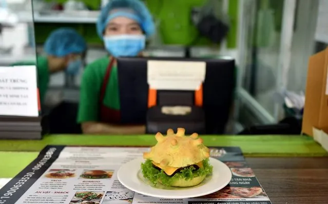 A coronavirus-themed burger is pictured at the Pizza Home restaurant in Hanoi on March 26, 2020, amid restrictions being put in place to contain the spread of the COVID-19 coronavirus. (Photo by Manan Vatsyayana/AFP Photo)
