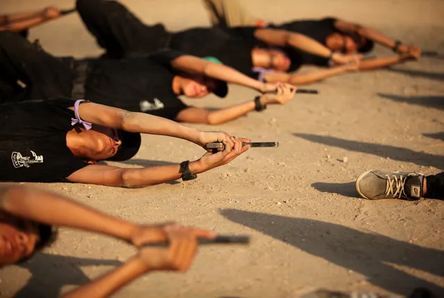 Palestinian youths take part in a military-style exercise at the Liberation Youths summer camp, organised by the Hamas movement in Gaza City on July 21, 2016.  (Photo by APA Images/Rex Features/Shutterstock)