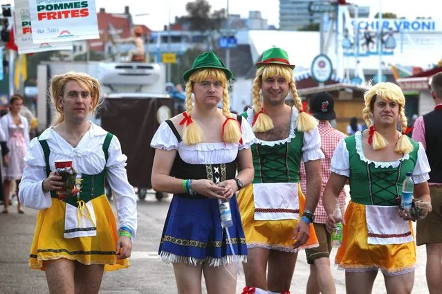 British visitors wearing Bavarian costumes walk ahead the opening of the traditional Bavarian Oktoberfest festival at the Theresienwiese in Munich, southern Germany, on September 20, 2014. (Photo by Karl-Josef Hildenbrand/AFP Photo/DPA)