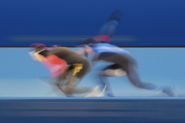 China's Gao Tingyu, left, compete against Kazakhstan's Yevgeniy Koshin during the men's 500m at the Speed Skating during the 9th Asian Winter Games in Harbin, China on Monday February 10, 2025. (Photo by Aaron Favila/AP Photo)