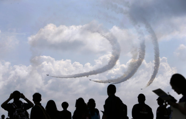 Republic of Singapore Air Force's Black Knights perform a manoeuvre during an aerial display at the Singapore Airshow, February 13, 2014. (Photo by Edgar Su/Reuters)