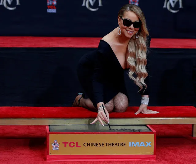 Singer Mariah Carey places her signature in cement in the forecourt of the TCL Chinese theatre in Los Angeles, California, U.S., November 1, 2017. (Photo by Mario Anzuoni/Reuters)