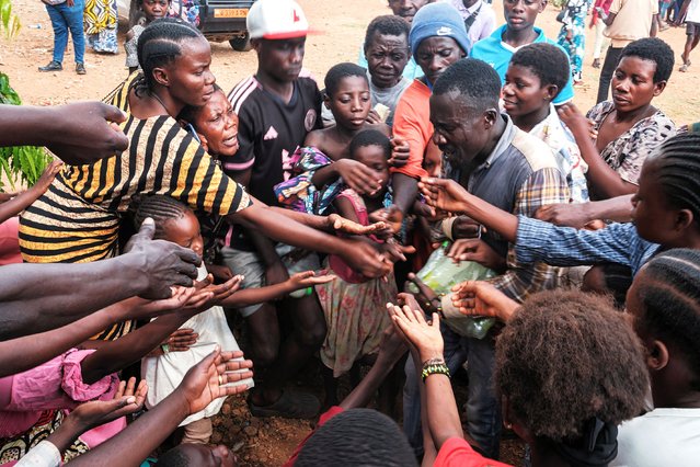 Congolese refugees, displaced by ongoing clashes in eastern Democratic Republic of Congo, gather to receive soft drinks from a social worker after their registration at the Gihanga refugee transit camp in Gihanga on February 17, 2025. Columns of M23 fighters allied with Rwandan troops on February 16, 2025 entered the centre of another key city in the eastern Democratic Republic of Congo as the African Union highlighted growing fears that the strife-torn country could break up, as scores of people have fled since the fighters reached outlying districts of Bukavu, capital of South Kivu province, on February 14, 2025. (Photo by Tchandrou Nitanga/AFP Photo)