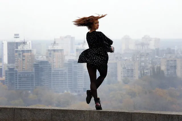 The wind blows a girl as she looks at the left bank of the Dnipro river in a city park in Kiev, Ukraine, Monday, November 6, 2017. (Photo by Efrem Lukatsky/AP Photo)