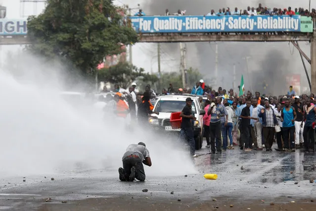 Water is sprayed by policemen to disperse supporters of Kenyan opposition leader Raila Odinga in Nairobi, Kenya on November 17, 2017. (Photo by Thomas Mukoya/Reuters)