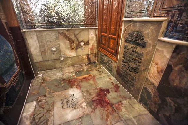 Bullet holes on the wall and blood on the ground are seen after gunmen attacked the Shah Cheragh shrine in the southern city of Shiraz, Iran, Wednesday, October 26, 2022. Gunmen attacked the major Shiite holy site in Iran on Wednesday, killing at least 15 people and wounding dozens. The attack came as protesters elsewhere in Iran marked a symbolic 40 days since a woman's death in custody ignited the biggest anti-government movement in over a decade. (Photo by Mohammadreza Dehdari/Iranian Students' News Agency, ISNA via AP Photo)