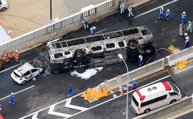 Photo taken from a Kyodo News helicopter on August 22, 2022, shows burnt remains of a bus after it overturned and caught fire in an accident that occurred earlier in the day near the Toyoyama-Minami interchange on the Nagoya Expressway in Aichi Prefecture in central Japan. (Photo by Kyodo News/AP Photo)