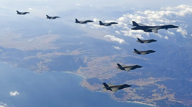 In this photo provided by South Korea Defense Ministry, U.S. Air Force B-1B bomber, right top, flies over the Korean Peninsula with South Korean fighter jets and U.S. fighter jets during the combined aerial exercise, South Korea, Wednesday, December 6, 2017. The United States flew a B-1B supersonic bomber over South Korea on Wednesday in part of a massive combined aerial exercise involving hundreds of warplanes, a clear warning after North Korea last week tested its biggest and most powerful missile yet. (Photo by South Korea Defense Ministry via AP Photo)
