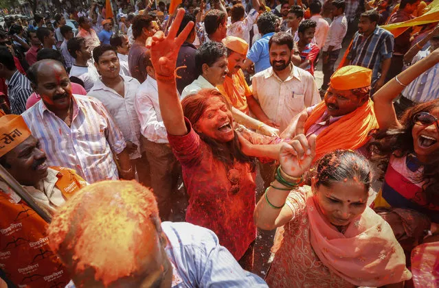 Supporters of the Shiv Sena party celebrate after learning of initial results of Maharashtra state election outside their party office in Mumbai October 19, 2014. Prime Minister Narendra Modi's Hindu nationalist party made big gains in two Indian state elections, partial results showed on Sunday, in an endorsement that will encourage him to step up the pace of economic reforms. (Photo by Shailesh Andrade/Reuters)
