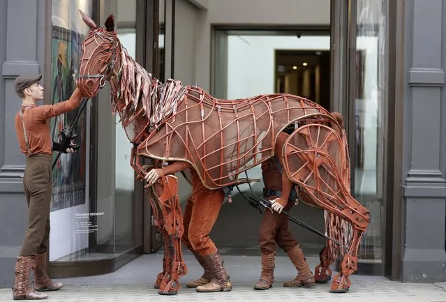 War Horse puppet Joey is walked along New Bond Street near Bonhams auction rooms in London, Tuesday, September 6, 2016. Joey, along with other puppets from the play that are being auctioned have no estimated price because they are being sold at a charity auction on Sept. 13, to raise money for the Handspring Trust, a not for profit organisation seeking to inspire creativity and innovation towards new puppet theatre arts. (Photo by Kirsty Wigglesworth/AP Photo)