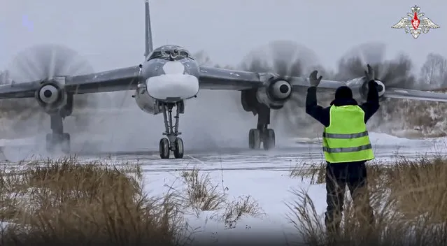 In this handout photo taken from video released by the Russian Defense Ministry Press Service on Wednesday, November 30, 2022, a view of a Tu-95 strategic bomber of the Russian air force taxiing before takeoff for a joint air patrol with Chinese bombers at an airbase in an unspecified location in Russia. Russian and Chinese strategic bombers on Wednesday flew a joint patrol over the western Pacific in a show of increasingly close defense ties between the two countries. (Photo by Russian Defense Ministry Press Service via AP Photo)
