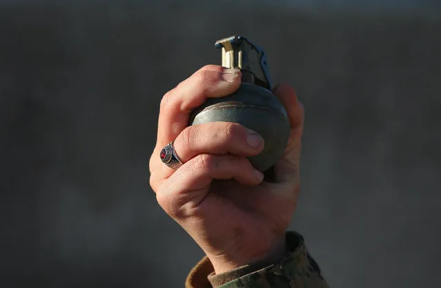 A female Marine prepares to throw a practice grenade during Marine Combat Training (MCT) on February 21, 2013 at Camp Lejeune, North Carolina.  Since 1988 all non-infantry enlisted male Marines have been required to complete 29 days of basic combat skills training at MCT after graduating from boot camp. MCT has been required for all enlisted female Marines since 1997. About six percent of enlisted Marines are female.  (Photo by Scott Olson)