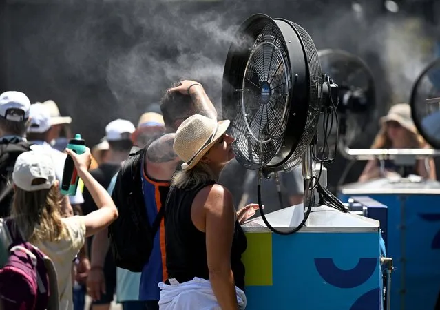 Spectators cool off during the 2023 Australian Open tennis tournament at Melbourne Park in Melbourne, Australia, 17 January 2023. (Photo by Lukas Coch/EPA/EFE/Rex Features/Shutterstock)