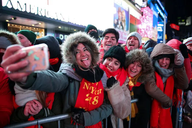 People take a picture in Times Square ahead of the New Year's Eve celebrations in Manhattan, New York, U.S., December 31, 2017. (Photo by Amr Alfiky/Reuters)
